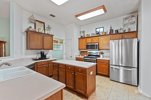 kitchen with brown cabinets, a kitchen island, stainless steel appliances, and a sink