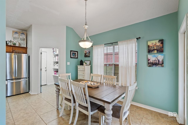 dining space with baseboards and light tile patterned floors