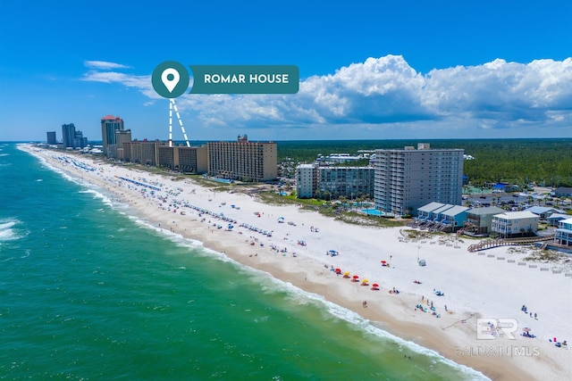 aerial view with a city view, a water view, and a beach view