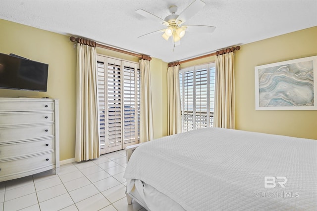 tiled bedroom featuring a textured ceiling, ceiling fan, and access to exterior