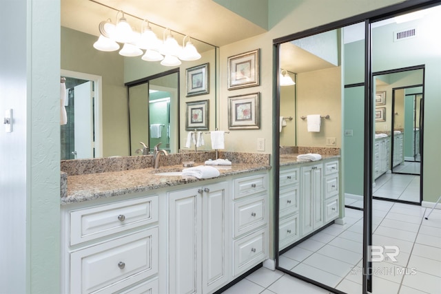 bathroom with tile patterned flooring, visible vents, and vanity