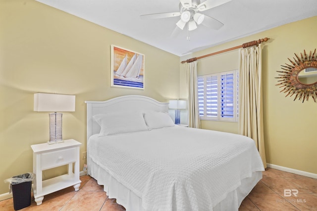 bedroom featuring baseboards, a ceiling fan, and tile patterned floors