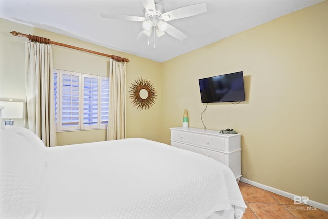 bedroom with light tile patterned flooring, ceiling fan, and baseboards