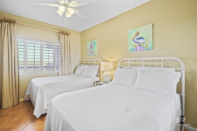 bedroom featuring ceiling fan, baseboards, and tile patterned floors