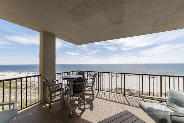 balcony with a beach view and a water view