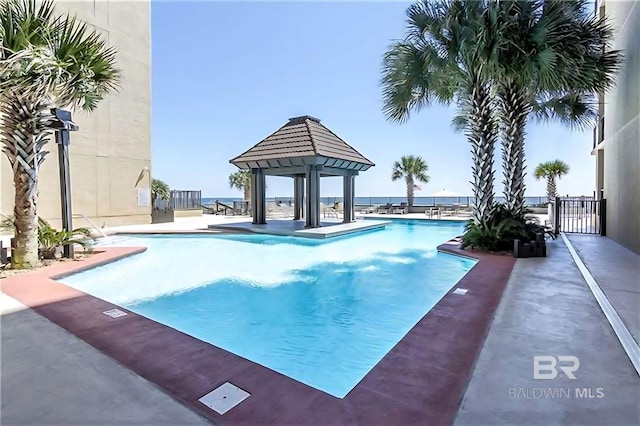 pool featuring a gazebo, a patio area, and fence