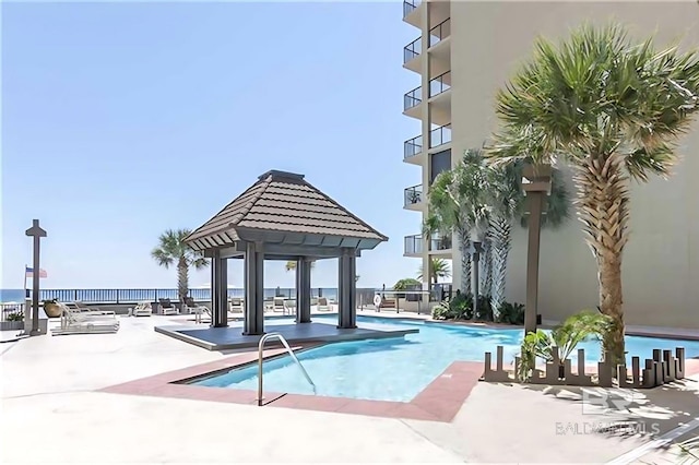 pool with a patio area and a gazebo