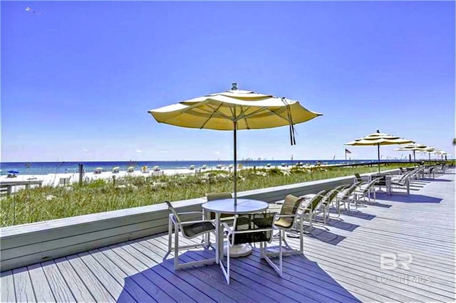 deck with a beach view and a water view