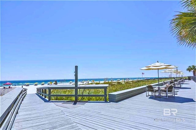 exterior space with a beach view and a deck with water view