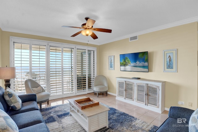 tiled living area featuring ceiling fan, baseboards, visible vents, and crown molding