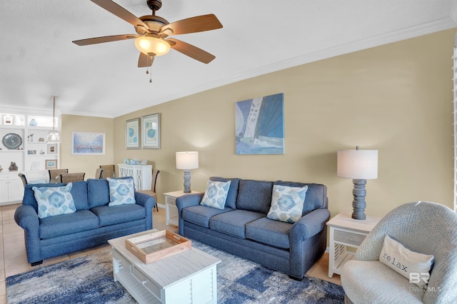 tiled living room featuring ceiling fan and crown molding