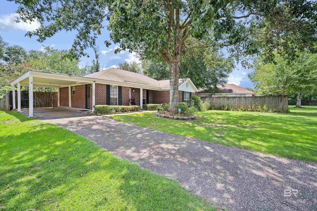 ranch-style home with a front yard and a carport