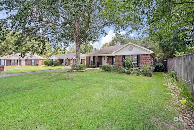 ranch-style home with a front lawn