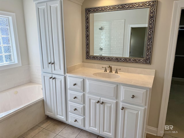 bathroom with tiled shower, vanity, a bath, and tile patterned floors