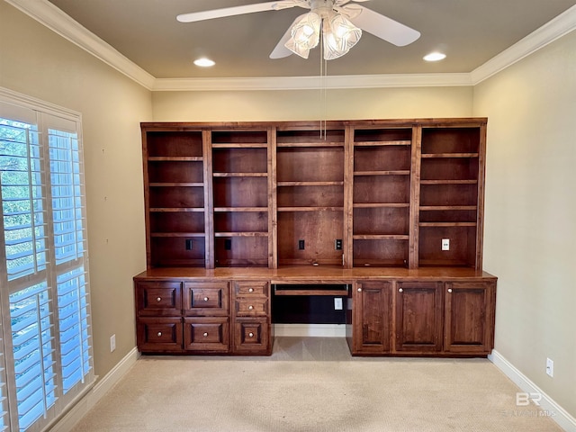 unfurnished office featuring ornamental molding, built in study area, light carpet, and baseboards