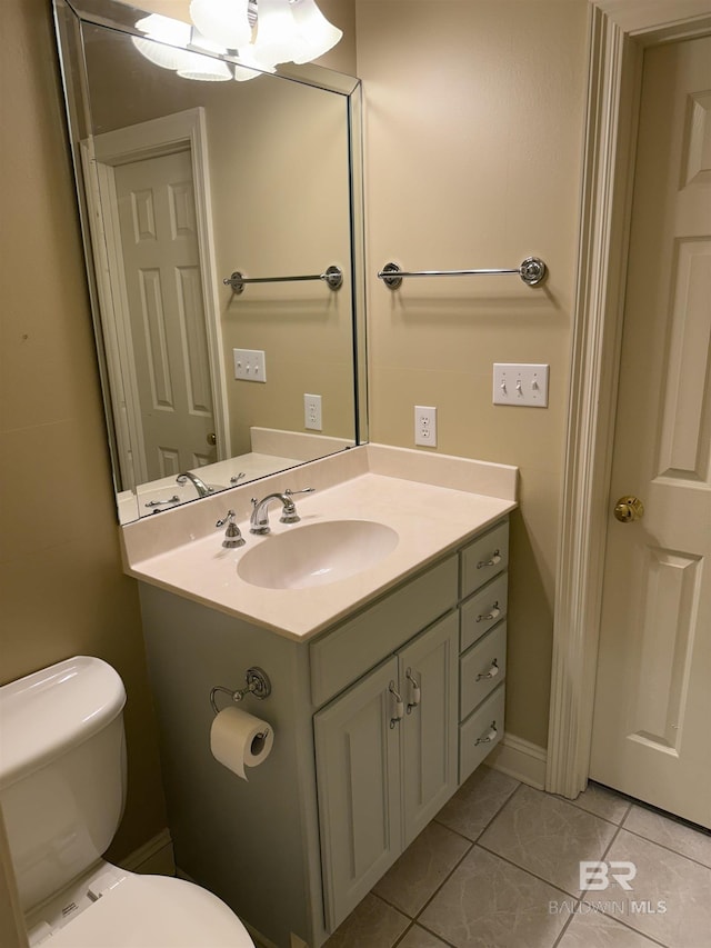 bathroom featuring vanity, toilet, and tile patterned floors