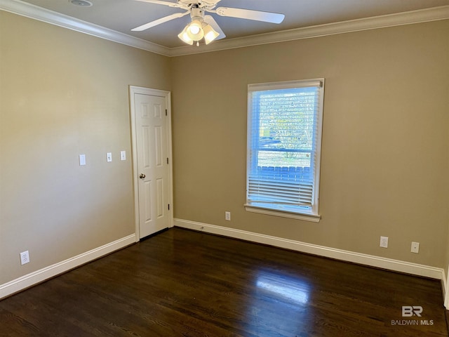 spare room with a ceiling fan, crown molding, baseboards, and wood finished floors