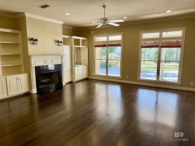 unfurnished living room featuring baseboards, visible vents, dark wood-style floors, a premium fireplace, and crown molding