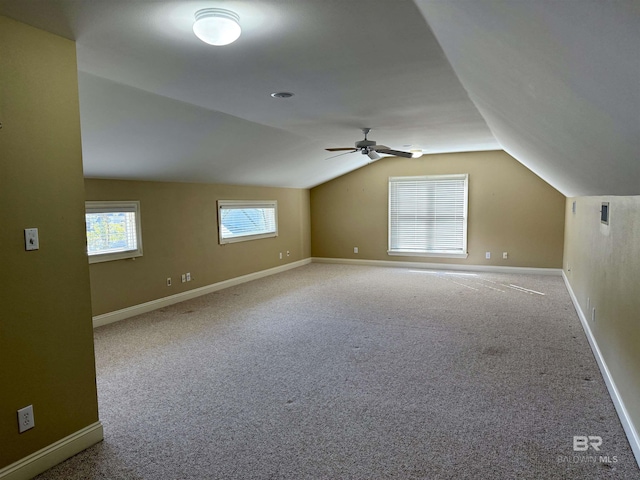 bonus room with carpet, baseboards, vaulted ceiling, and a ceiling fan