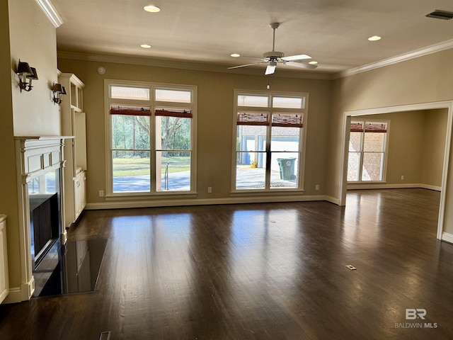 unfurnished living room featuring ornamental molding, plenty of natural light, dark wood finished floors, and visible vents