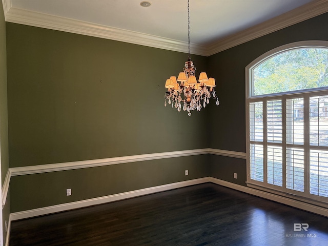 empty room with dark wood-style flooring, crown molding, baseboards, and an inviting chandelier