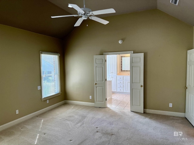 spare room with high vaulted ceiling, light carpet, baseboards, and a ceiling fan