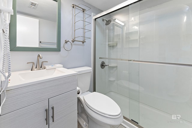 bathroom with vanity, toilet, and walk in shower