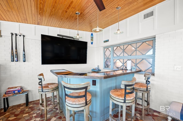 bar with pendant lighting, visible vents, wooden ceiling, and brick wall