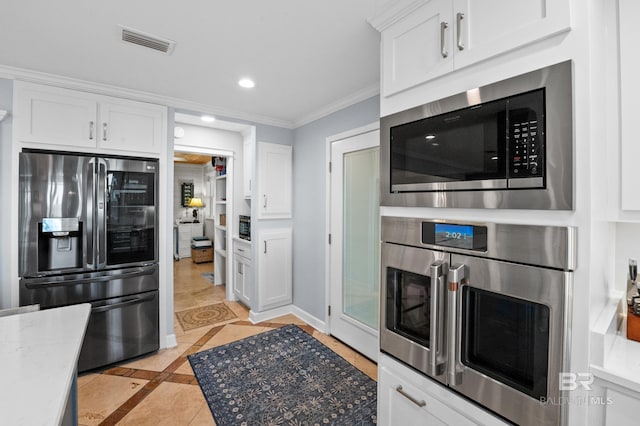 kitchen featuring recessed lighting, visible vents, white cabinetry, appliances with stainless steel finishes, and crown molding