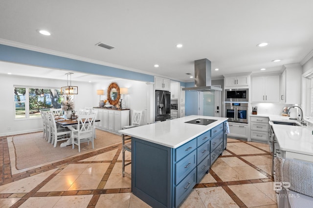 kitchen featuring light countertops, recessed lighting, island exhaust hood, and baseboards