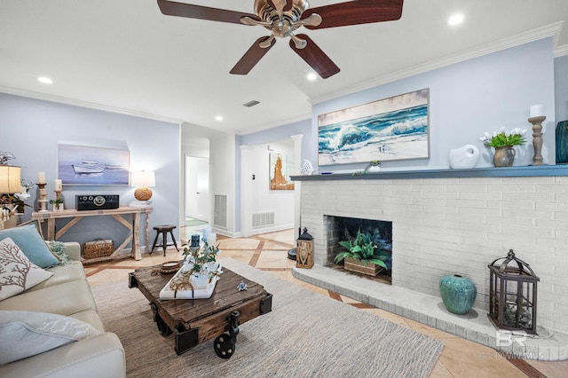 living room featuring ornamental molding, recessed lighting, a brick fireplace, and visible vents