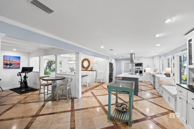 kitchen with baseboards, white cabinets, and recessed lighting