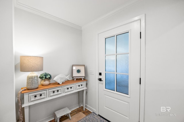 entryway with baseboards and crown molding