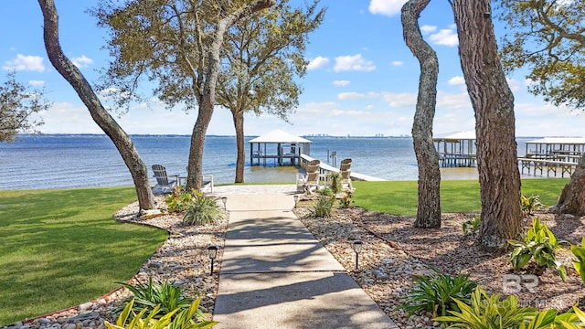 dock area featuring a water view and a yard