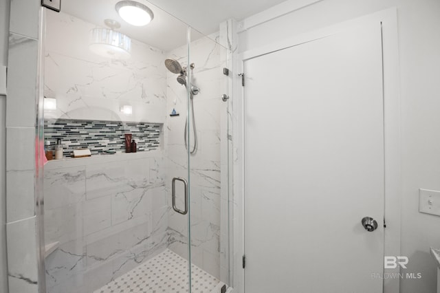 full bath with a marble finish shower