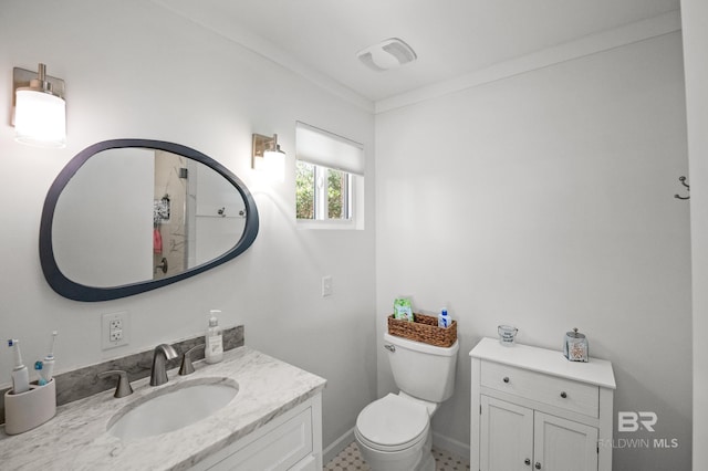 bathroom with vanity, toilet, and baseboards