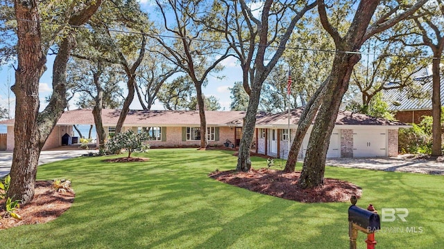 single story home with a garage, brick siding, and a front yard