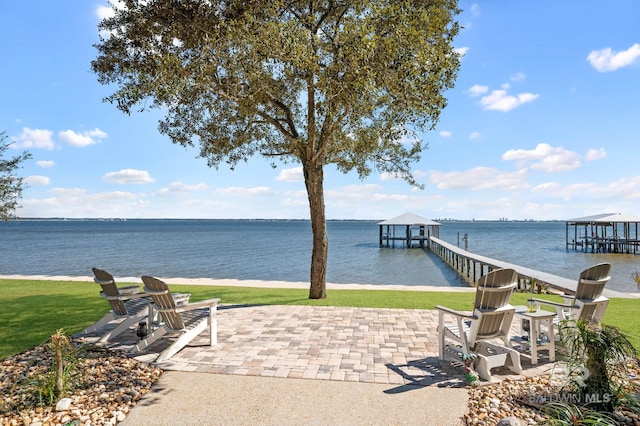 view of patio / terrace featuring a water view and a boat dock