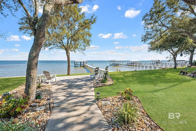 surrounding community with a yard, a boat dock, and a water view