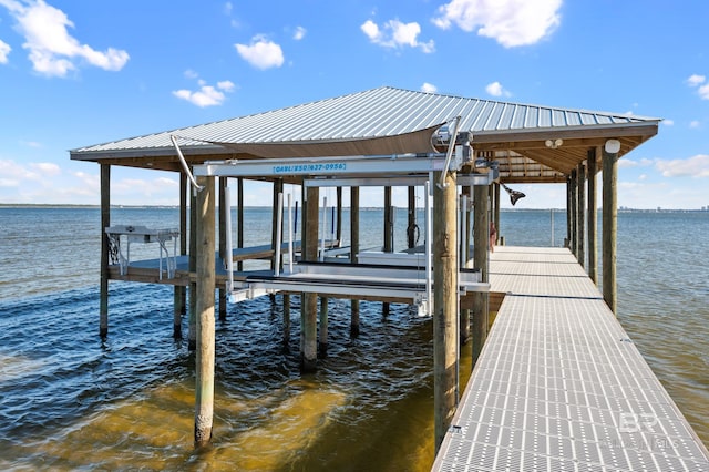 dock area with a water view and boat lift