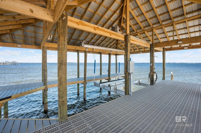 dock area with a water view and boat lift