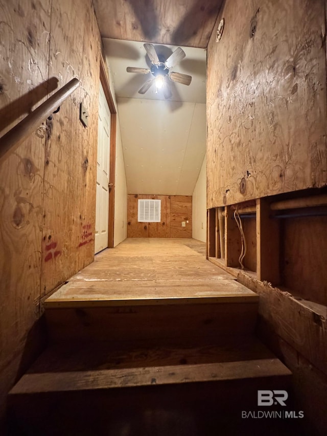 additional living space featuring ceiling fan, lofted ceiling, and visible vents