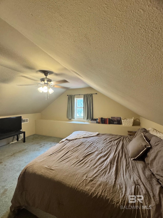 carpeted bedroom featuring lofted ceiling, ceiling fan, and a textured ceiling