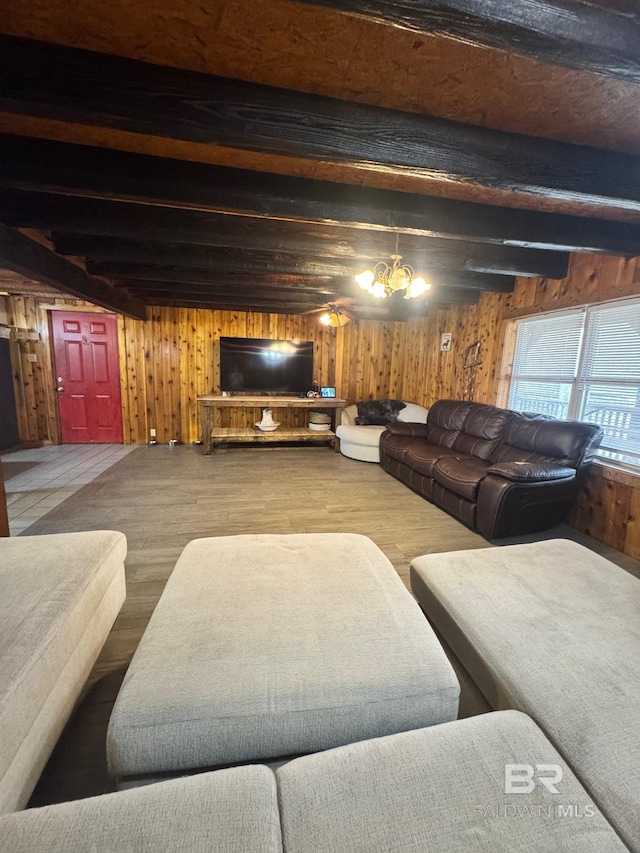 living area with wood walls, wood finished floors, and beam ceiling