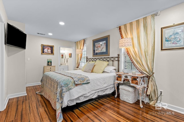 bedroom with connected bathroom, recessed lighting, wood finished floors, visible vents, and baseboards