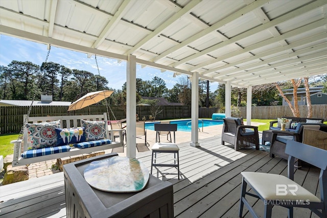 deck with a fenced backyard, outdoor lounge area, and a fenced in pool