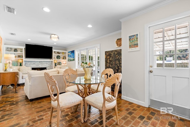 dining area featuring brick floor, recessed lighting, visible vents, baseboards, and crown molding