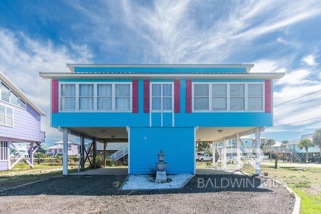 rear view of property with a carport