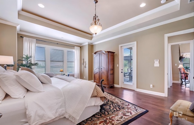 bedroom featuring access to outside, a tray ceiling, and dark wood-type flooring