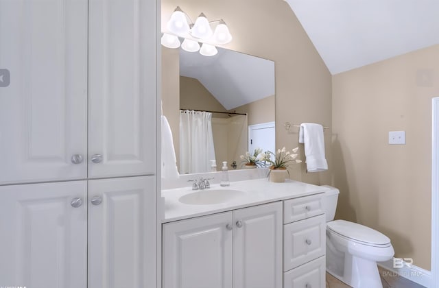 full bath featuring lofted ceiling, toilet, and vanity